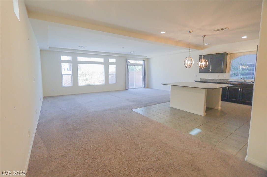6418 Jackson Spring Road Las Vegas, NV 89118 - Photo 18 of 20 An open floor plan seamlessly connects the kitchen with the primary living space, bathed in natural light.