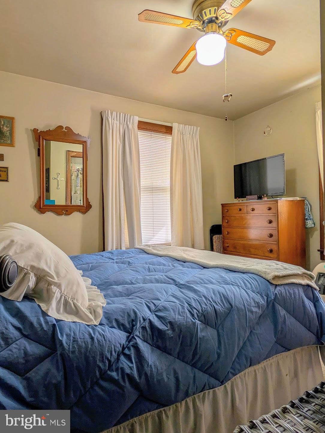 83 State Street Everett, PA 15537 - Photo 15 of 39 a bedroom with a bed and a chandelier