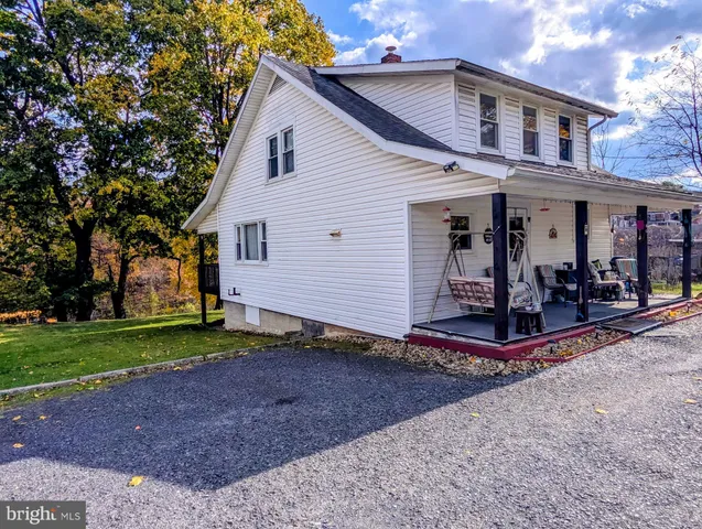 a view of a house with backyard and trees