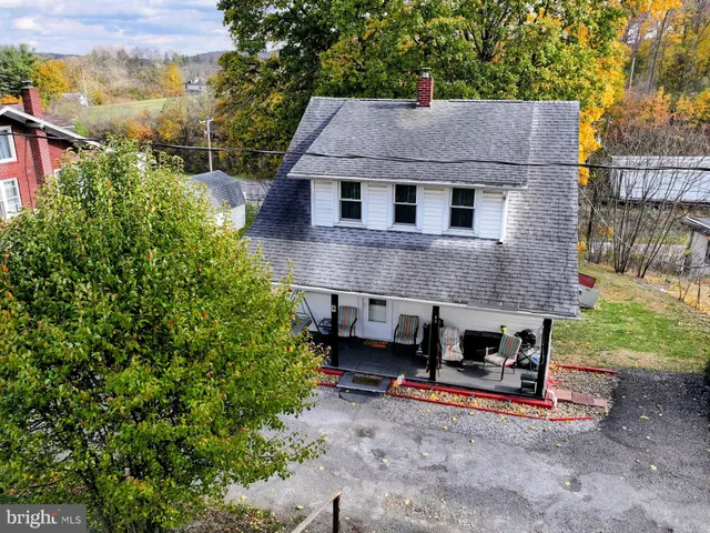 an aerial view of a house with a yard