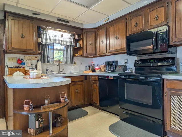 a kitchen with stainless steel appliances granite countertop a sink stove and microwave