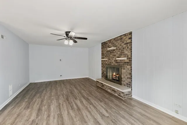 wooden floor in an empty room with a fireplace