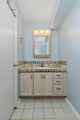 a bathroom with a sink vanity and mirror