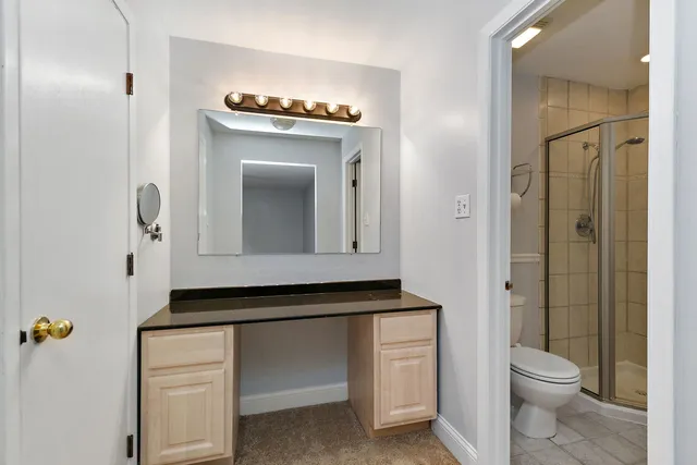 a bathroom with a toilet sink and mirror