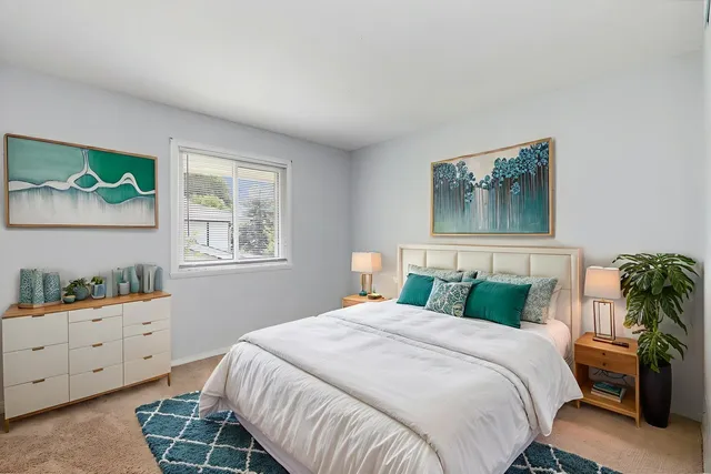 a bedroom with a bed and a window