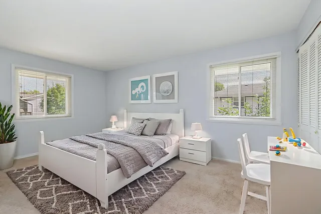 a room with a bed and a table chair