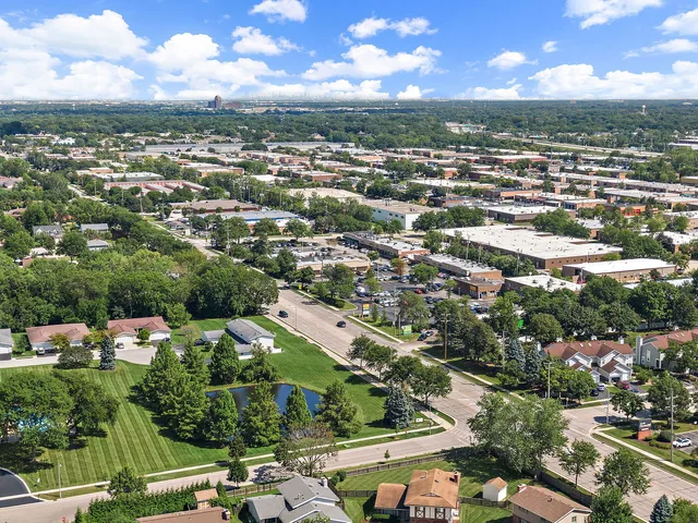 an aerial view of residential houses with city view