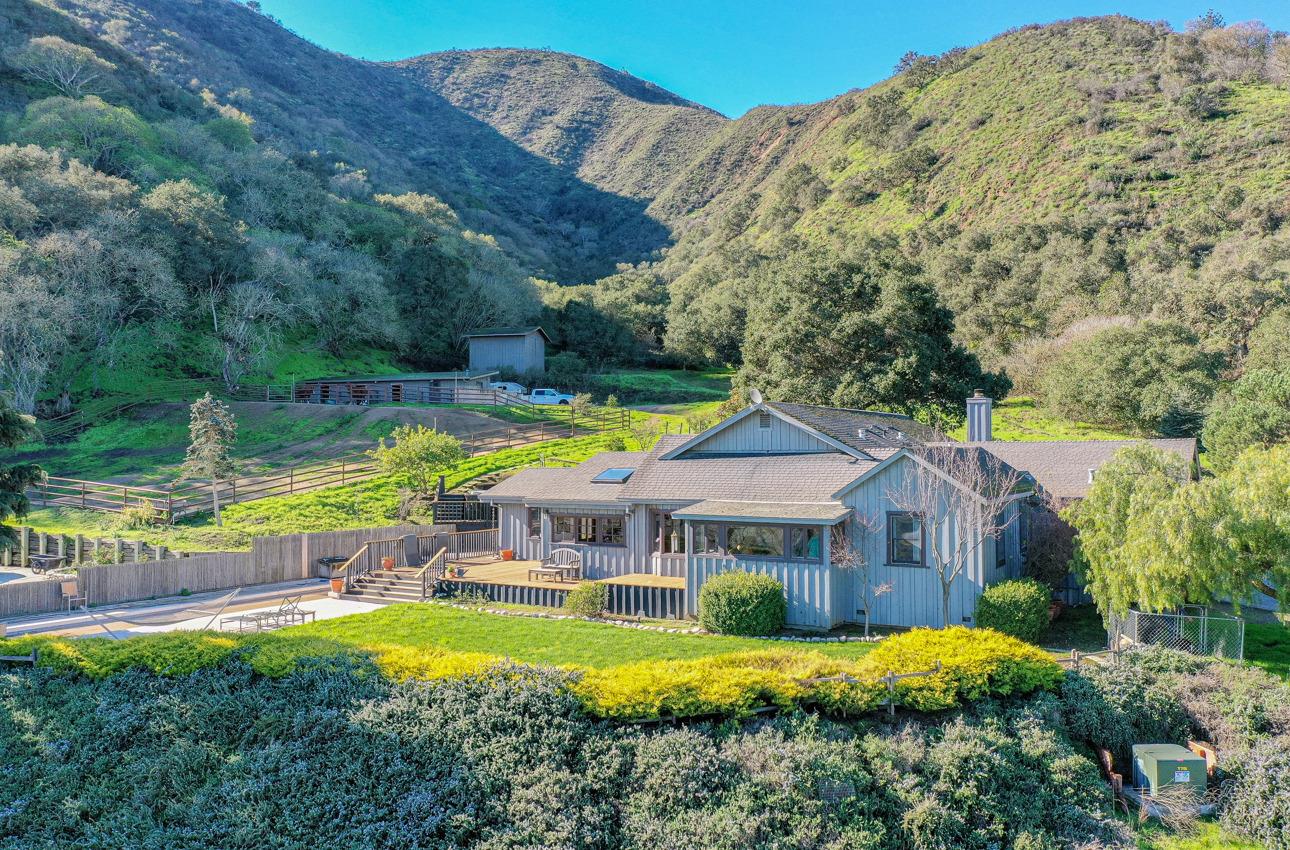 a view of a house with swimming pool and a yard