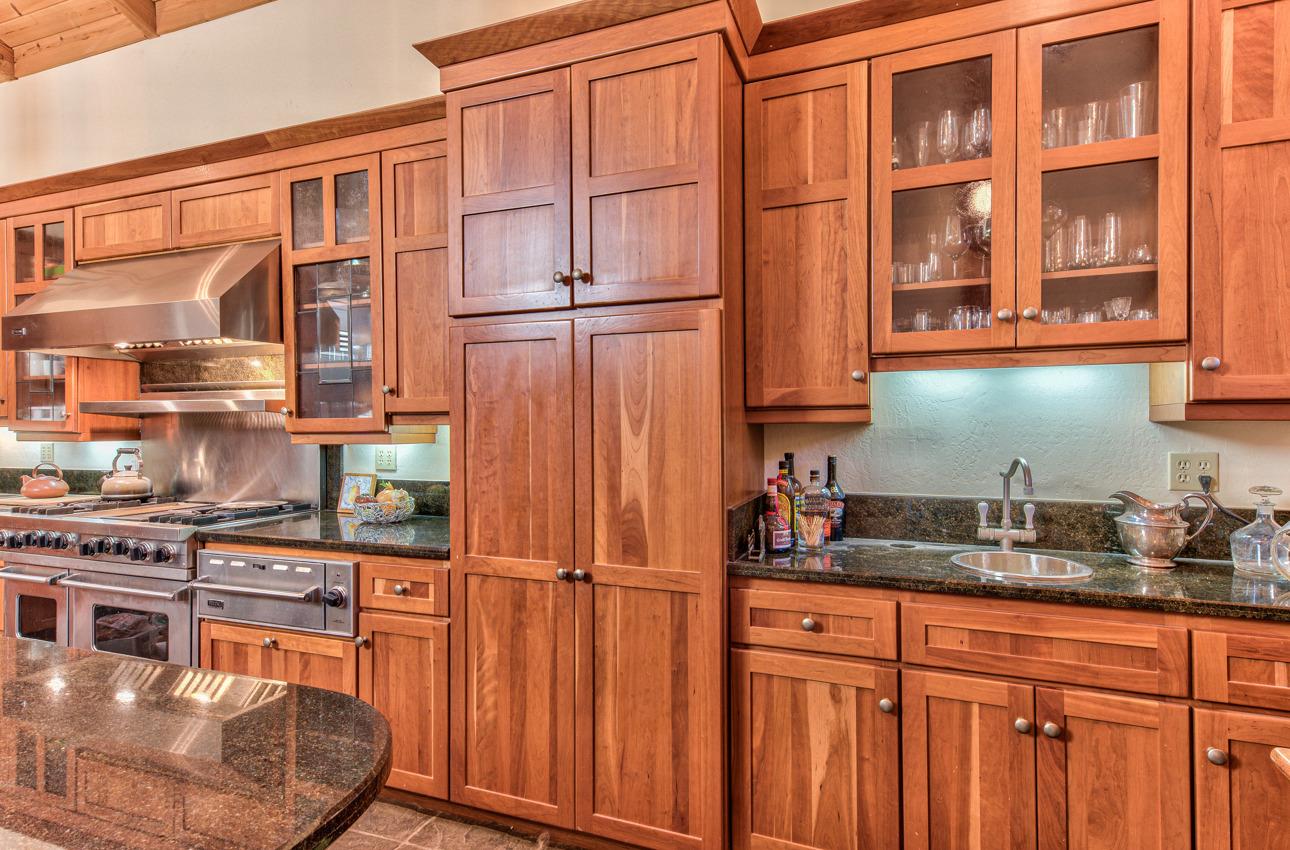 1352 C River Road Salinas, CA 93908 - Photo 19 of 35 a kitchen with stainless steel appliances granite countertop a refrigerator a stove and a sink with wooden cabinets