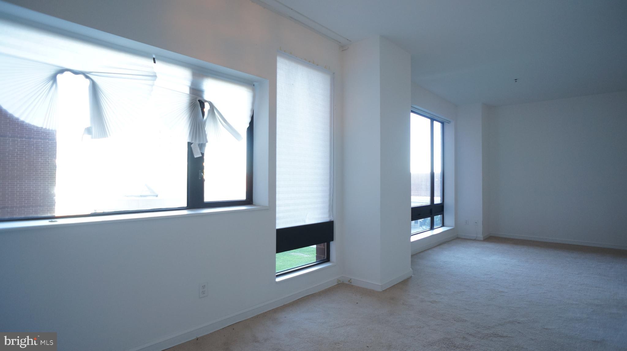 10 East Lee Street, Unit 705 Baltimore, MD 21202 - Photo 11 of 48 an empty room with windows