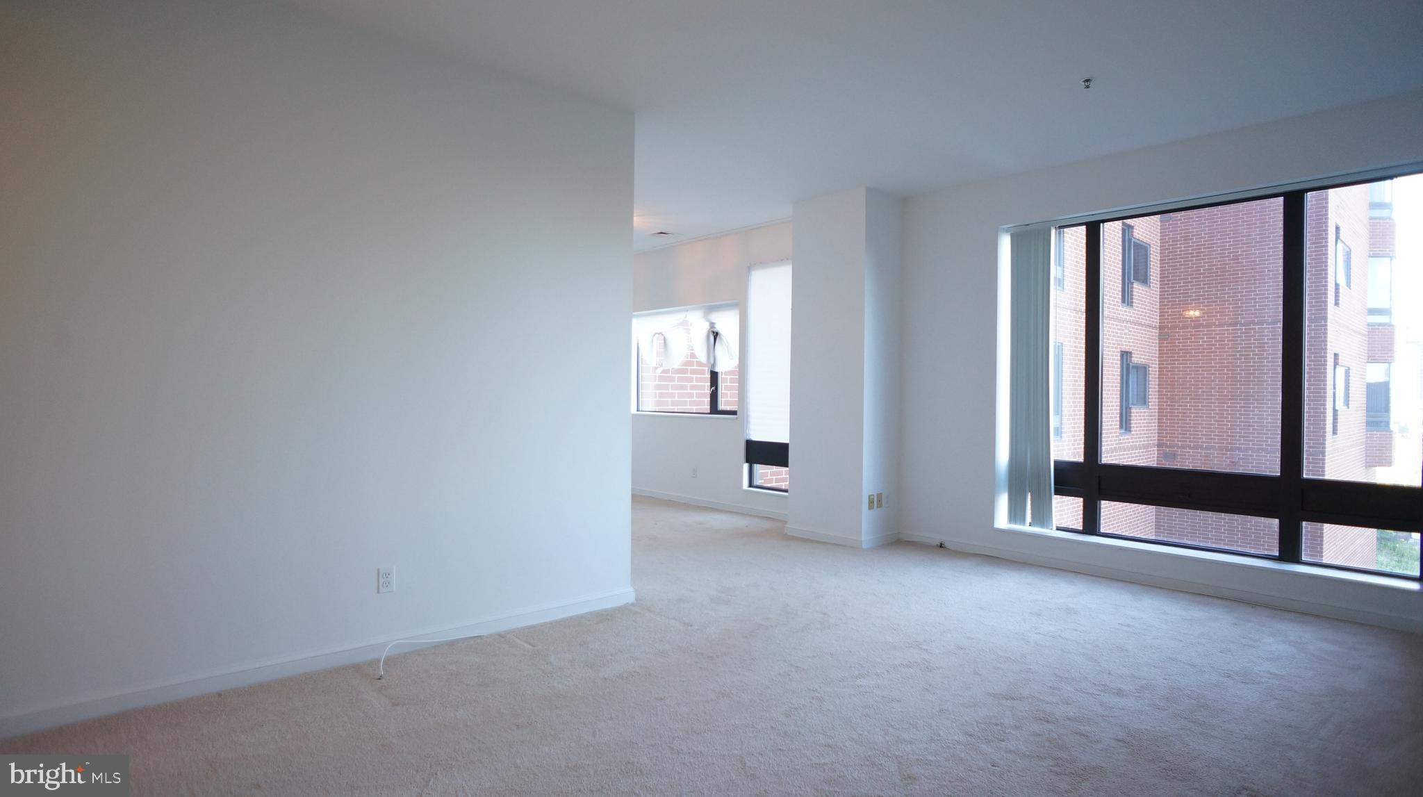 10 East Lee Street, Unit 705 Baltimore, MD 21202 - Photo 16 of 48 an empty room with windows