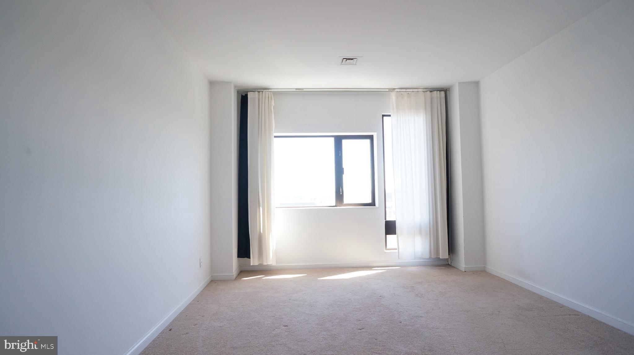 10 East Lee Street, Unit 705 Baltimore, MD 21202 - Photo 20 of 48 a view of empty room with windows