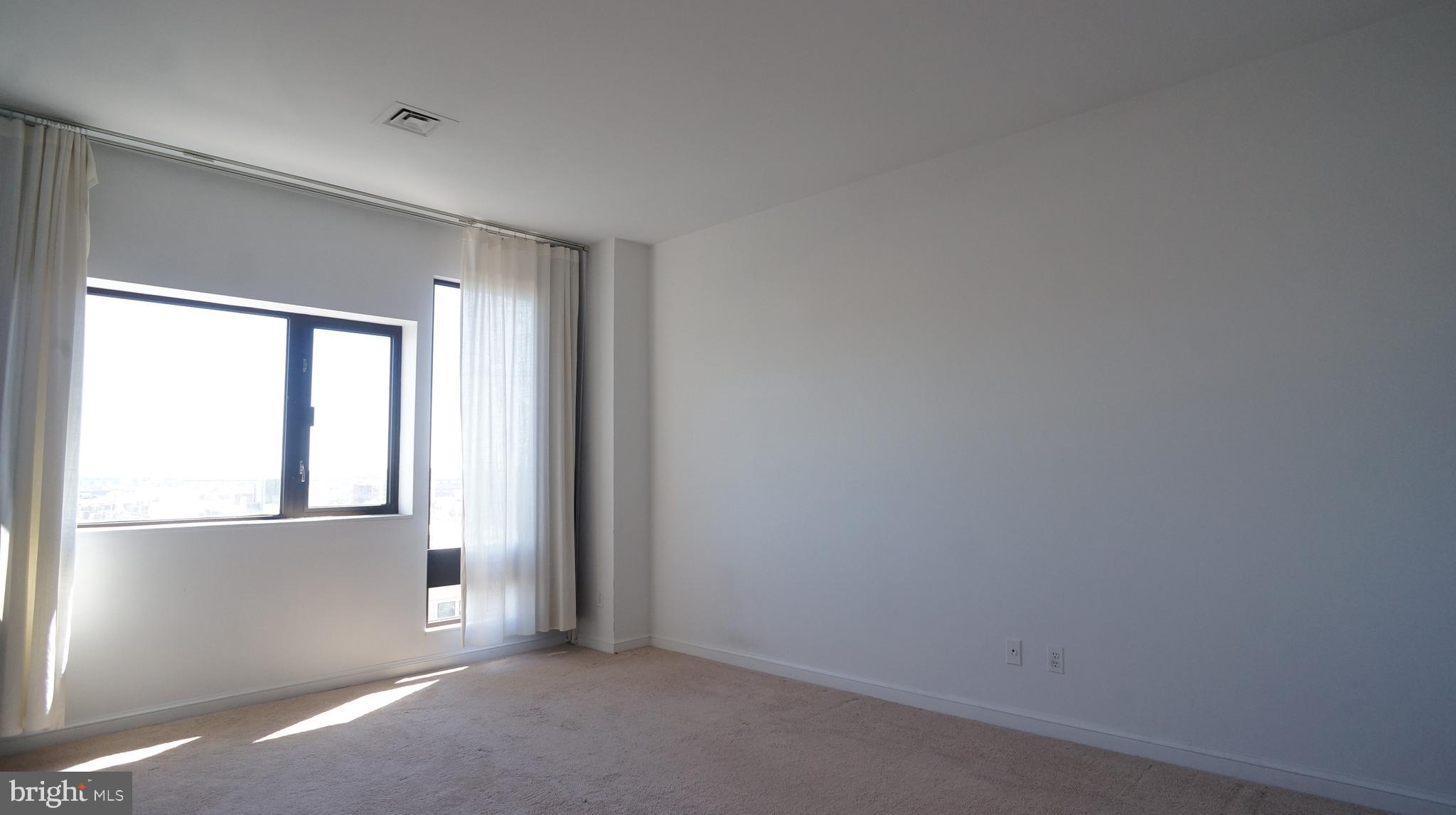 10 East Lee Street, Unit 705 Baltimore, MD 21202 - Photo 23 of 48 an empty room with windows