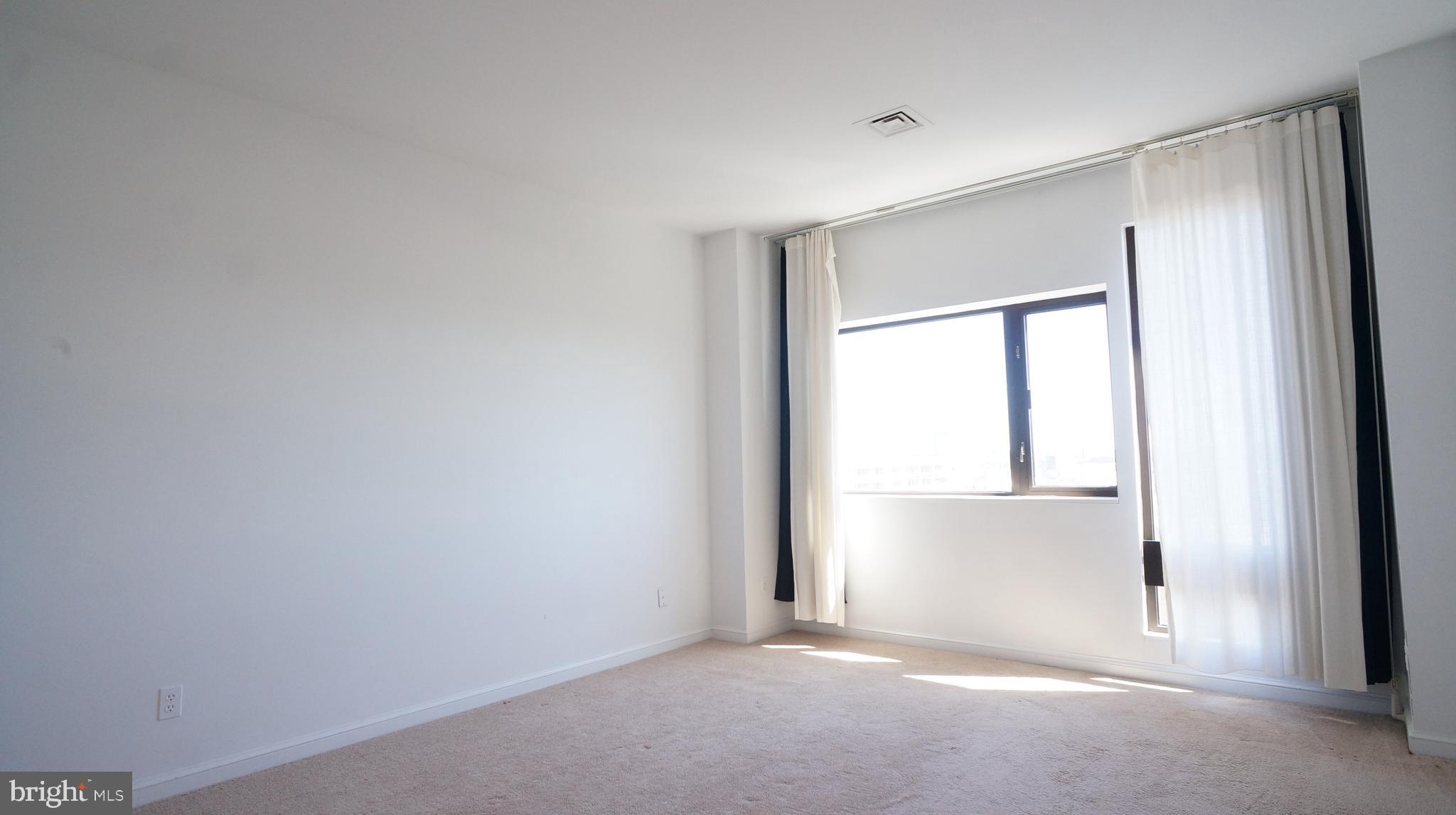 10 East Lee Street, Unit 705 Baltimore, MD 21202 - Photo 24 of 48 a view of an empty room with a window