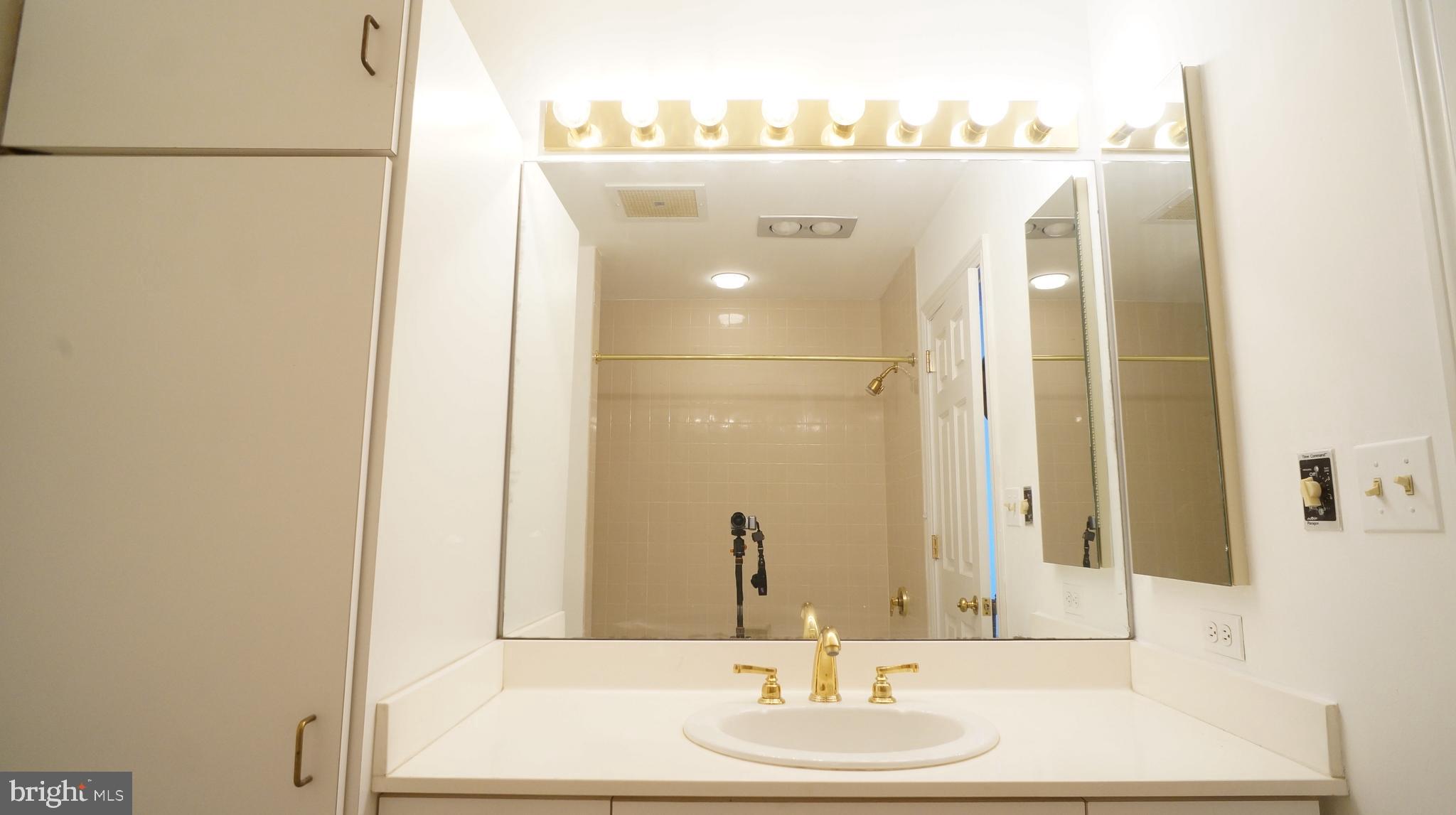 10 East Lee Street, Unit 705 Baltimore, MD 21202 - Photo 26 of 48 a bathroom with a sink and a mirror