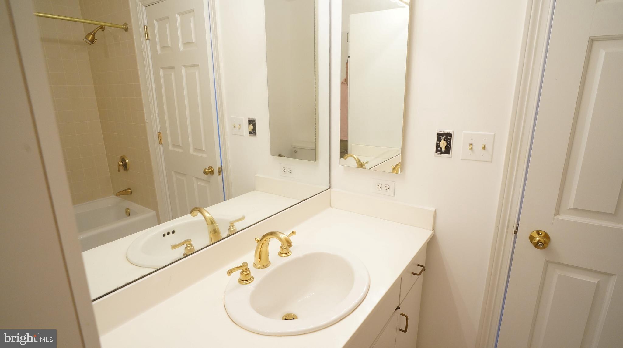 10 East Lee Street, Unit 705 Baltimore, MD 21202 - Photo 27 of 48 a bathroom with a sink and a mirror