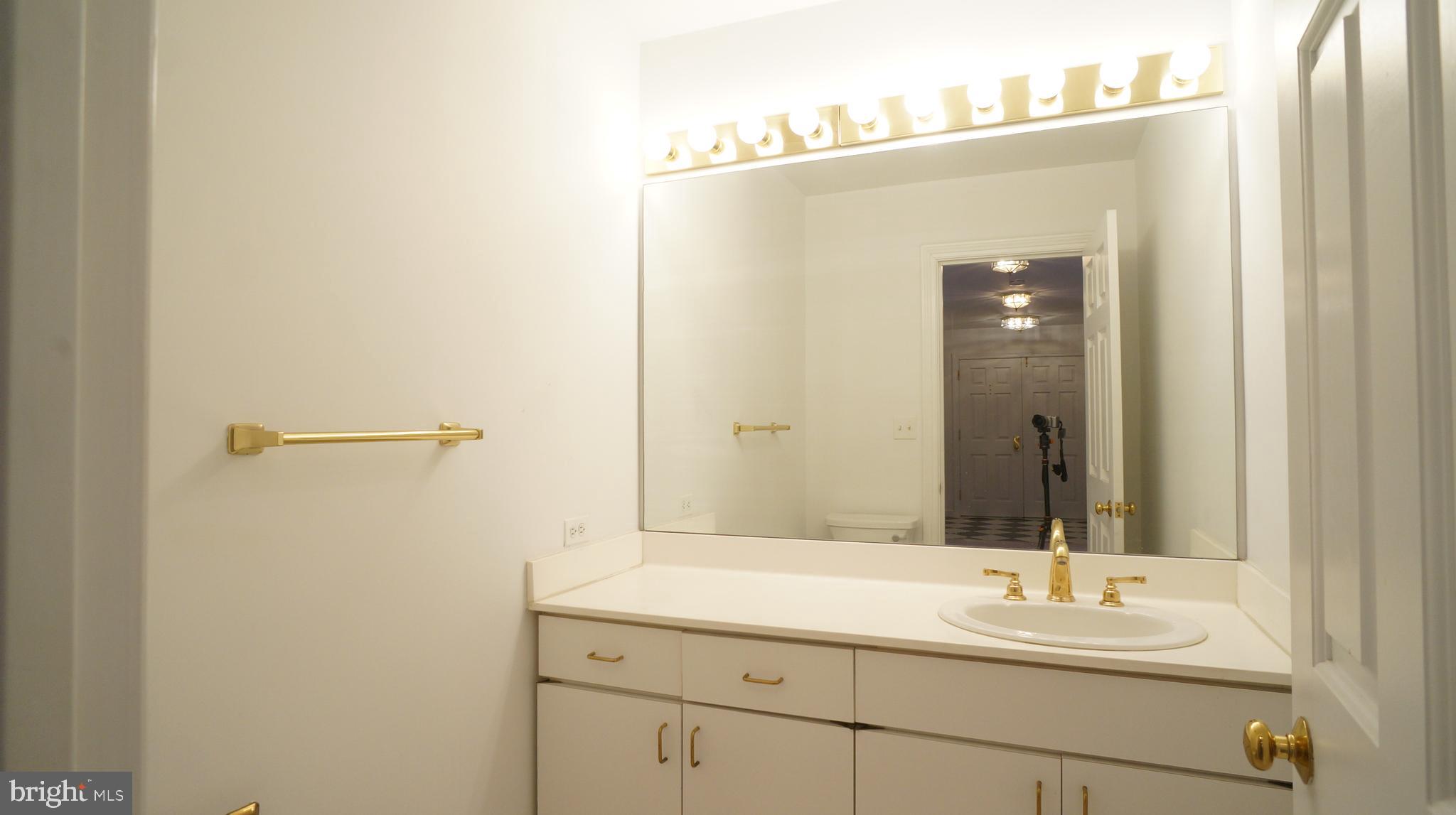 10 East Lee Street, Unit 705 Baltimore, MD 21202 - Photo 31 of 48 a bathroom with a sink and a mirror