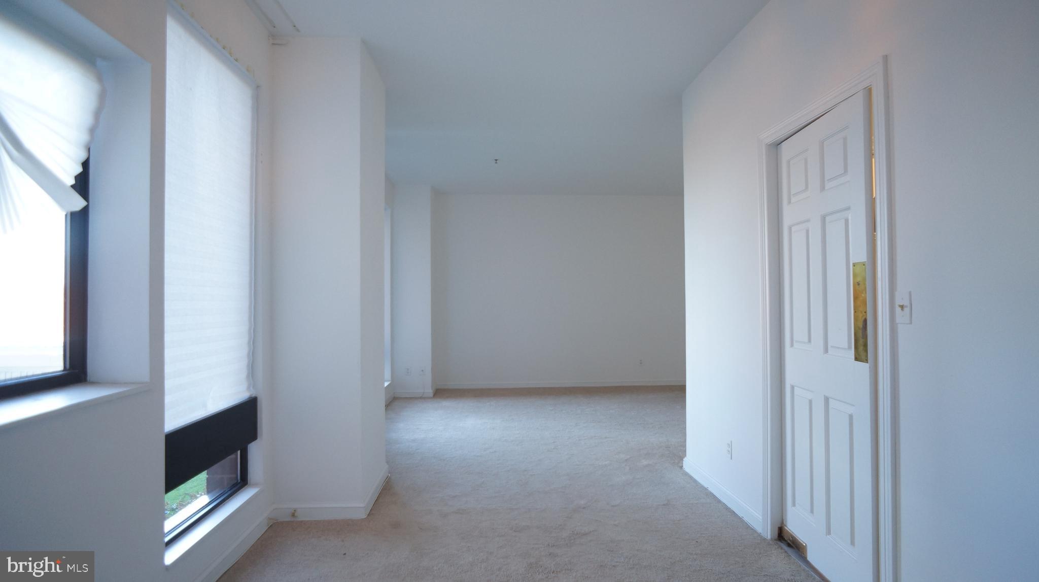 10 East Lee Street, Unit 705 Baltimore, MD 21202 - Photo 35 of 48 a view of an empty room with a window and fire place