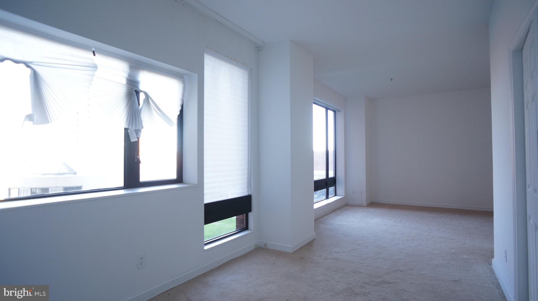 10 East Lee Street, Unit 705 Baltimore, MD 21202 - Photo 36 of 48 a view of an empty room with a window