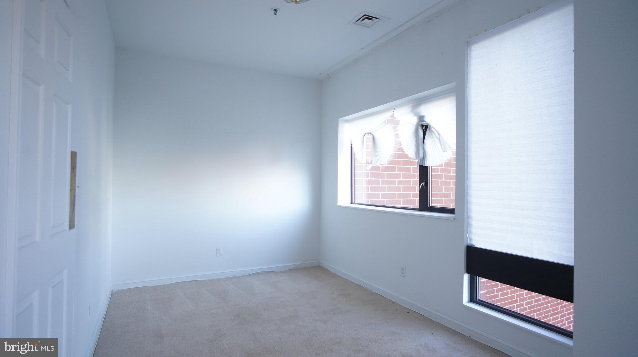 10 East Lee Street, Unit 705 Baltimore, MD 21202 - Photo 38 of 48 an empty room with windows