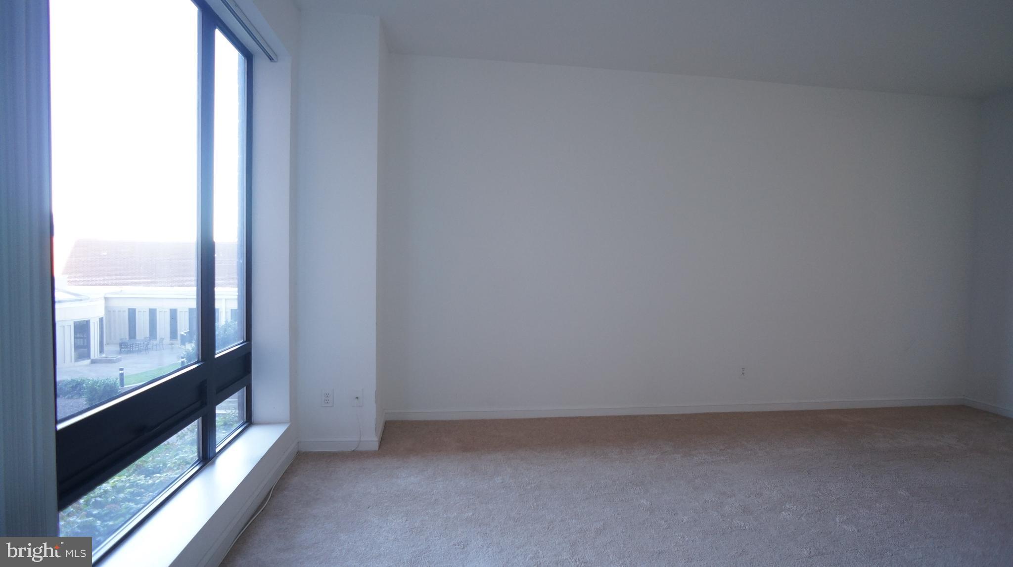 10 East Lee Street, Unit 705 Baltimore, MD 21202 - Photo 39 of 48 a view of an empty room and window