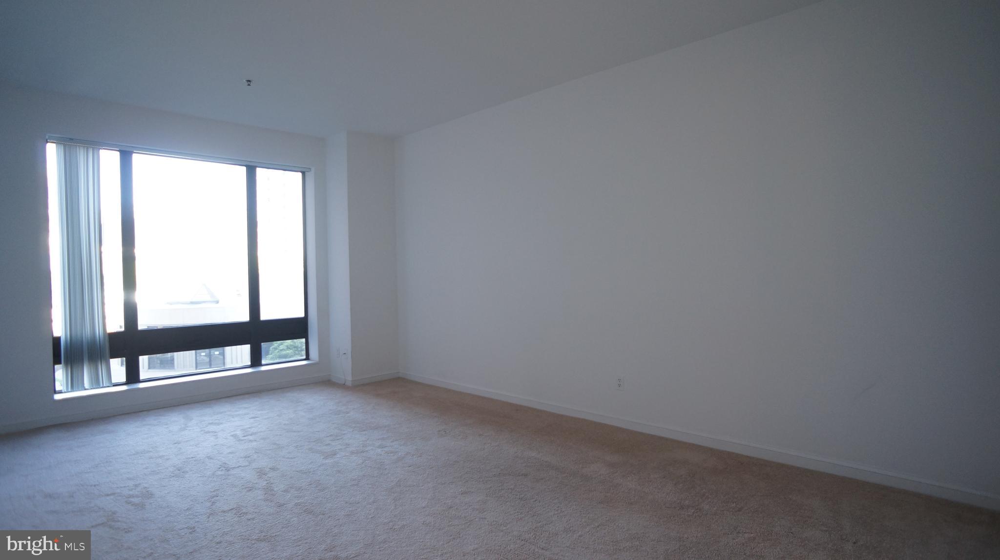 10 East Lee Street, Unit 705 Baltimore, MD 21202 - Photo 41 of 48 a view of an empty room with a window