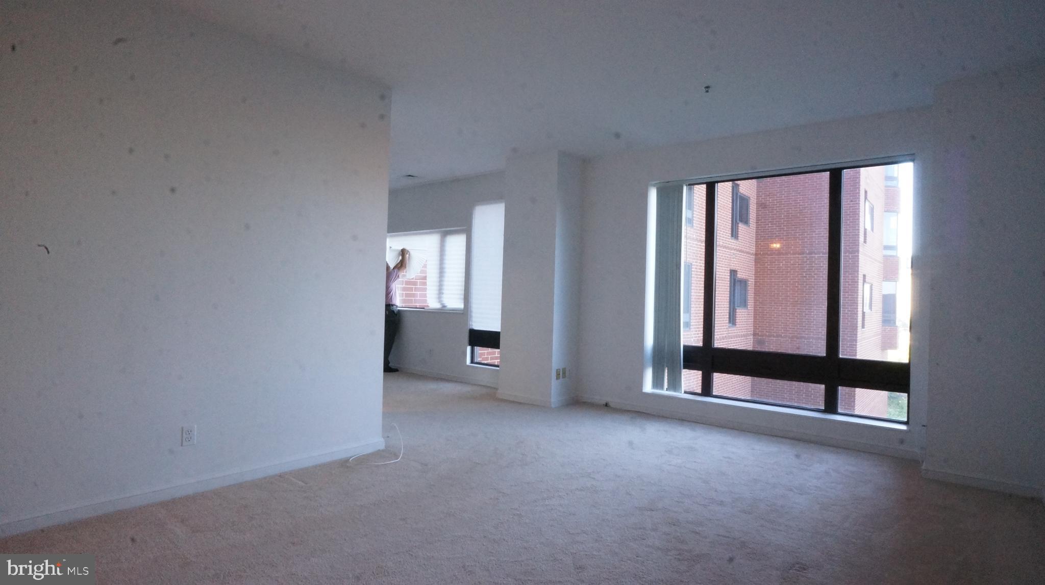 10 East Lee Street, Unit 705 Baltimore, MD 21202 - Photo 42 of 48 an empty room with windows