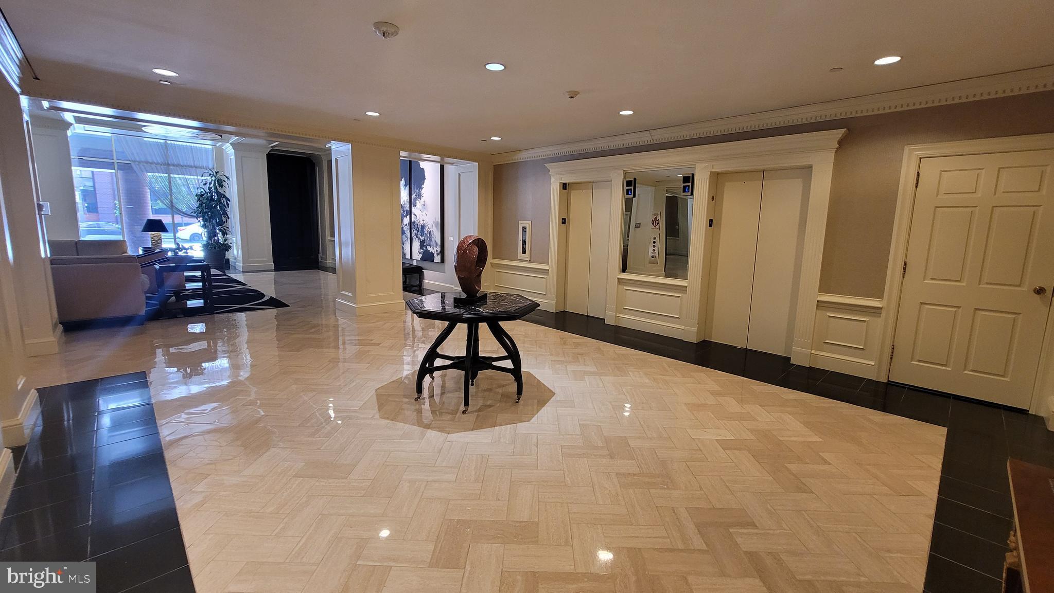 10 East Lee Street, Unit 705 Baltimore, MD 21202 - Photo 46 of 48 a view of a lobby with furniture and floor to ceiling window