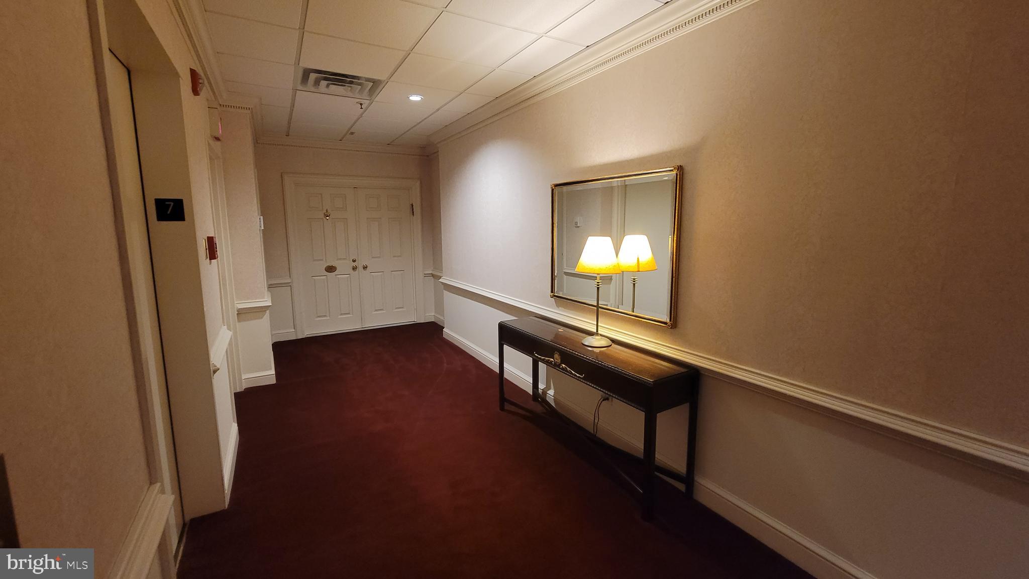 10 East Lee Street, Unit 705 Baltimore, MD 21202 - Photo 9 of 48 an empty room with wooden floor and windows