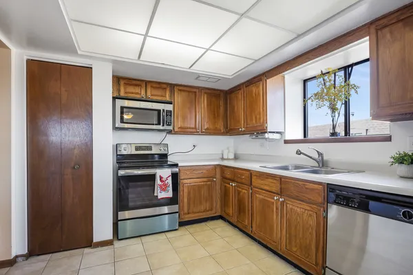 a kitchen with stainless steel appliances granite countertop a sink and cabinets