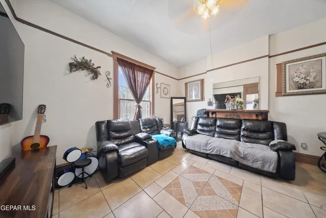 a living room with furniture and a floor to ceiling window