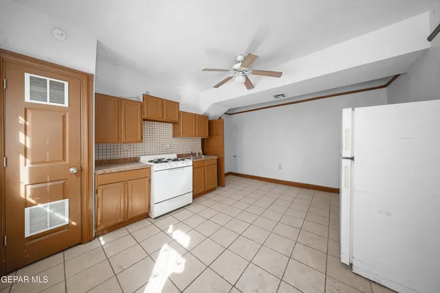 a view of a kitchen with microwave and windows