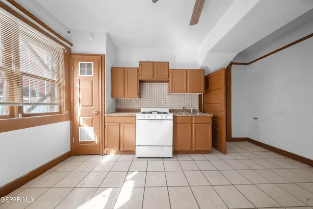 a view of a livingroom with a ceiling fan and window