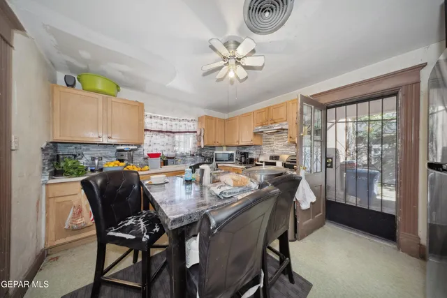 a dining room with furniture and window