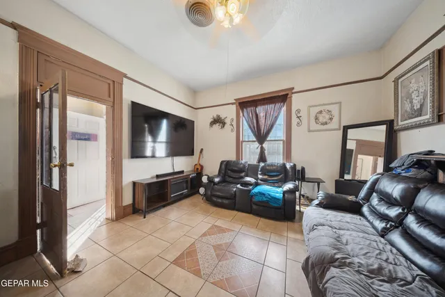a living room with furniture chess table and a large mirror