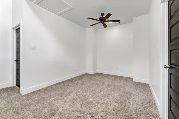 a view of a room with a ceiling fan