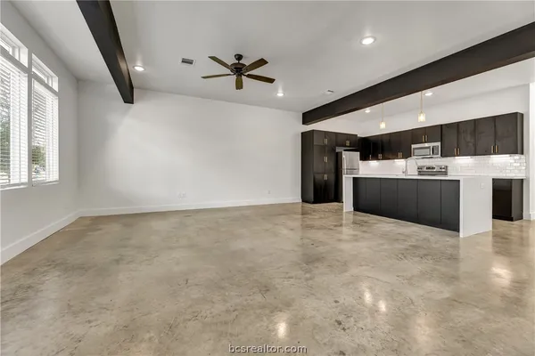 a view of a kitchen with a sink and cabinets
