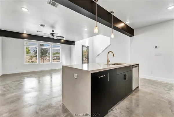 a kitchen with stainless steel appliances granite countertop a sink and a stove top oven