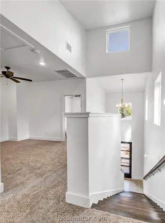 a view of a refrigerator in kitchen and an empty room