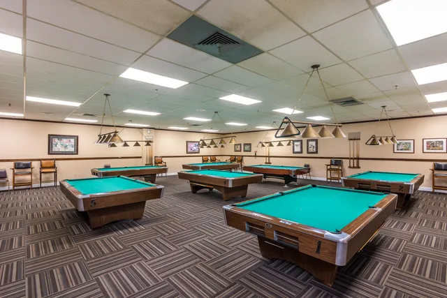 a room with furniture and pool table