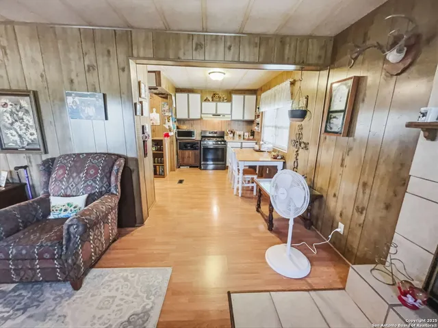 a living room with lots of furniture and wooden floor