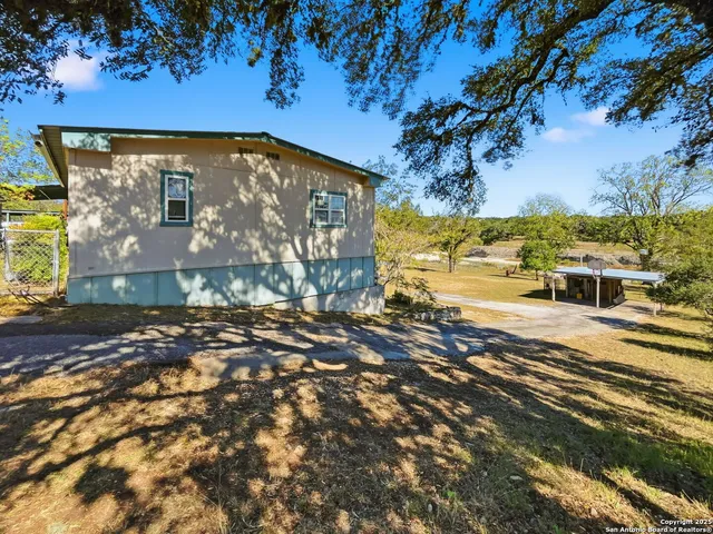 a view of a house with a tree