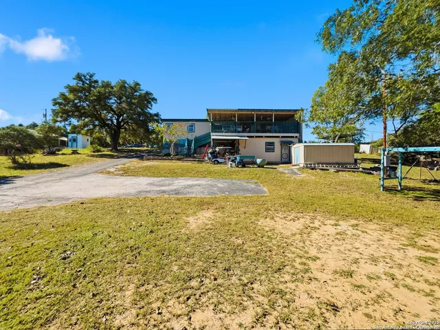 a view of a swimming pool with a lawn chairs under an umbrella