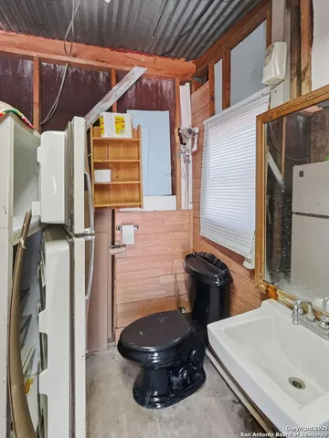 a bathroom with a sink a toilet and a mirror
