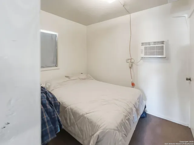 a bedroom with a bed and a mirror