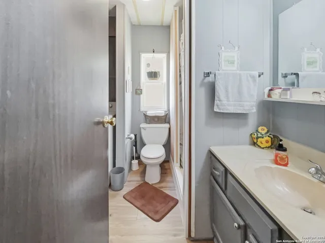 a bathroom with a sink toilet vanity and tub