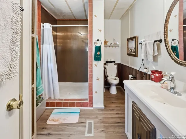 a bathroom with a sink a mirror and a shower