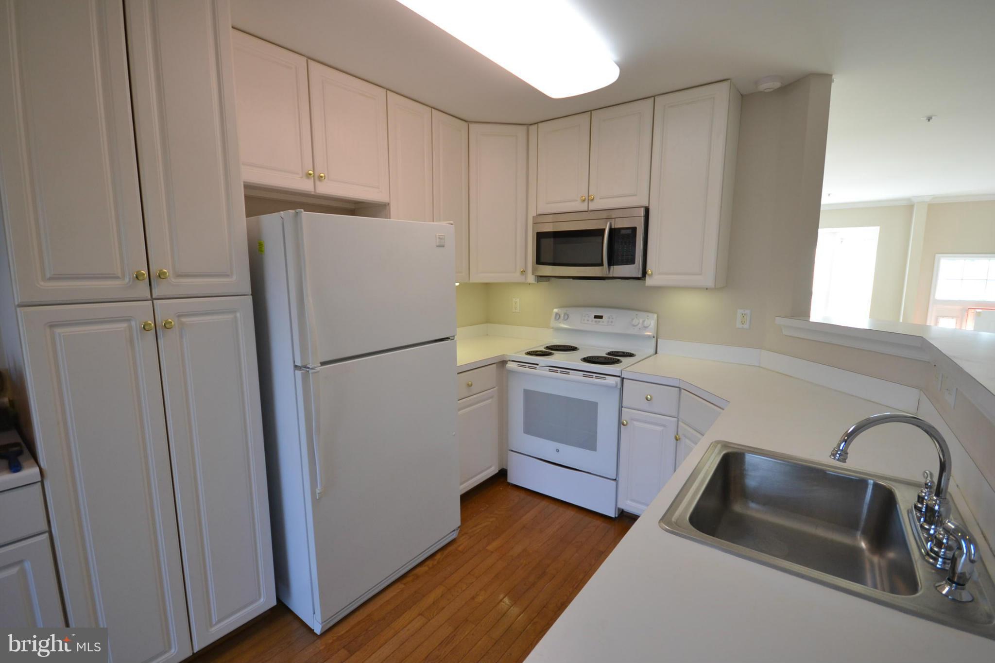 2629 Caulfield Court Frederick, MD 21701 - Photo 6 of 17 a kitchen with a refrigerator stove and sink