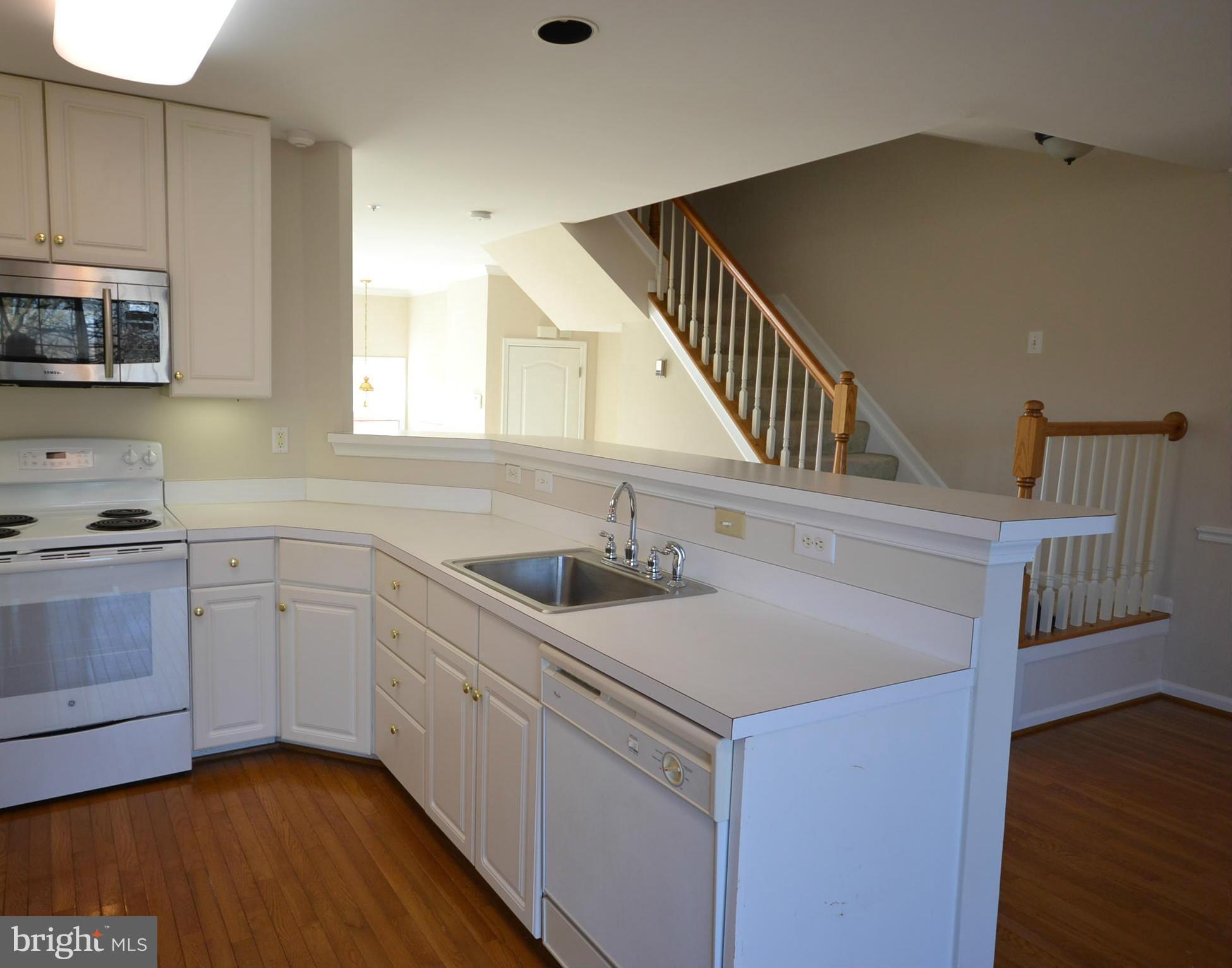 2629 Caulfield Court Frederick, MD 21701 - Photo 7 of 17 a kitchen with sink cabinets and wooden floor