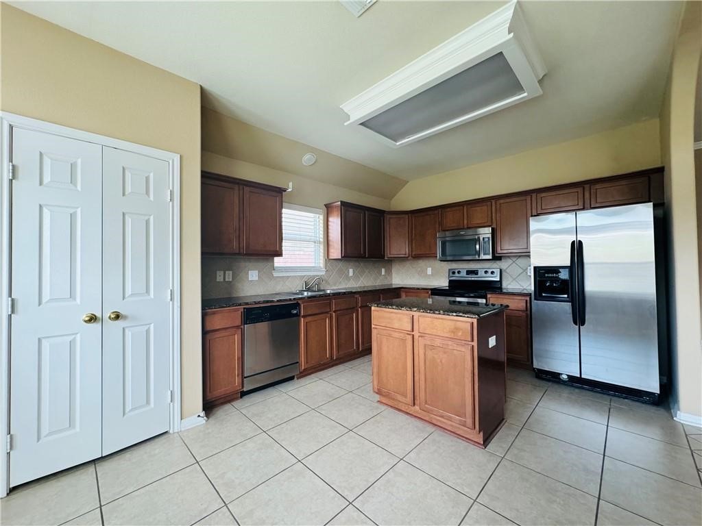 7541 Exeter Corpus Christi, TX 78414 - Photo 3 of 13 a large kitchen with stainless steel appliances granite countertop a refrigerator and a sink